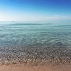 Scenic view of calm sea against blue sky