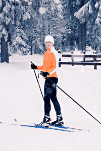 Full length of woman skiing on snow