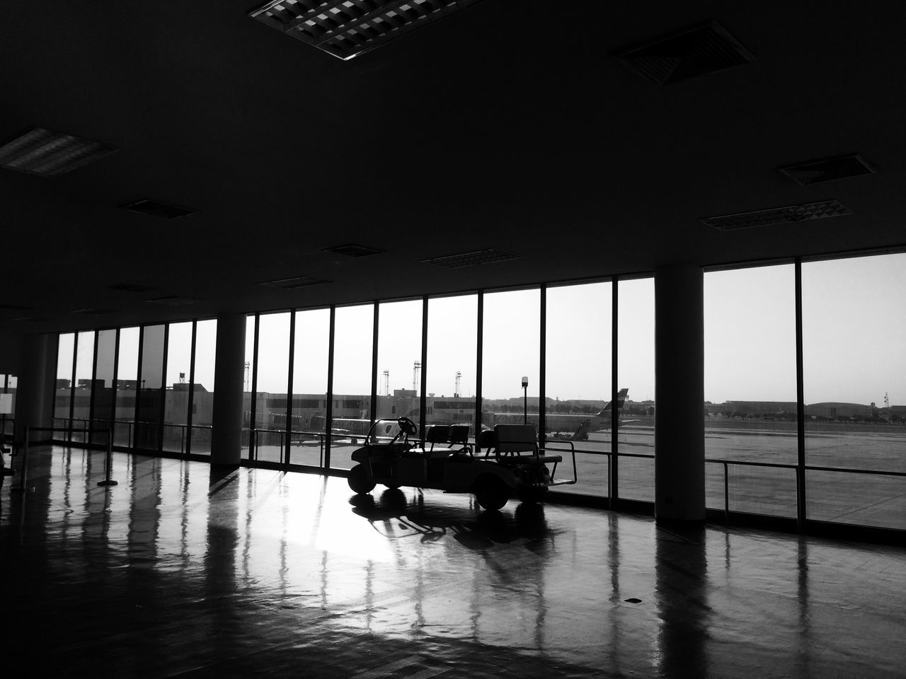 transportation, water, mode of transport, sea, silhouette, nautical vessel, built structure, indoors, men, reflection, travel, window, architecture, airport, horizon over water, boat, lifestyles, unrecognizable person