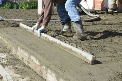 Low section of male worker working at construction site