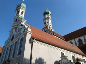 Low angle view of bell tower against blue sky