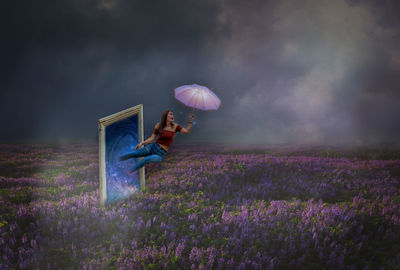 Woman standing on field with purple flowers