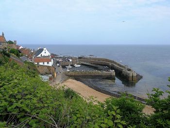 High angle view of sea and buildings against sky