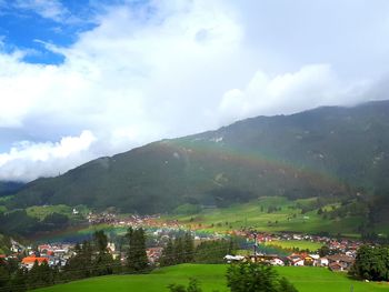 Scenic view of mountains and buildings against sky