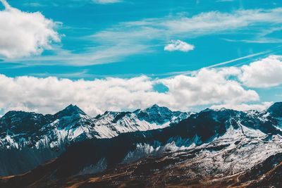 Scenic view of snowcapped mountains against sky