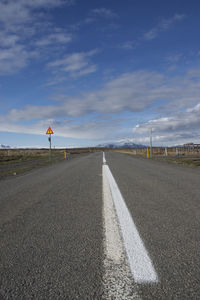 Road sign against sky