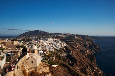 High angle view of townscape by sea against sky