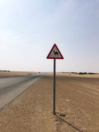 Road sign against clear sky