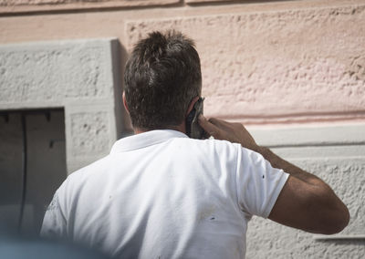 Rear view of man on wall