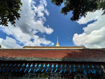 Low angle view of roof and building against sky