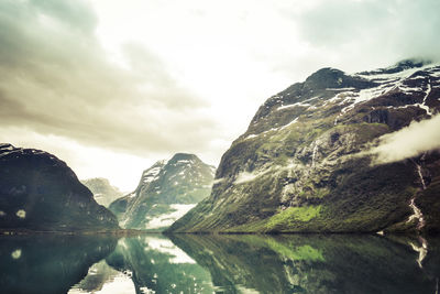 Scenic view of mountains against cloudy sky