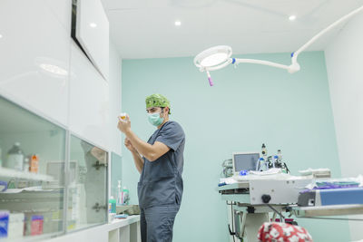 Veterinarian preparing syringe at clinic