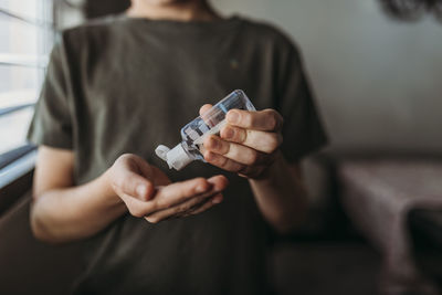 Midsection of man holding while standing at home