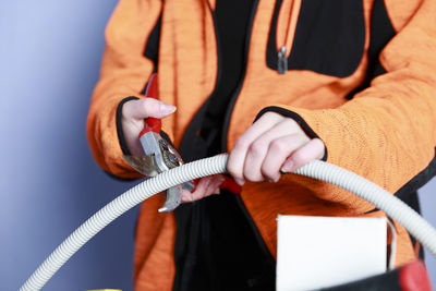 Young woman cutting pipe