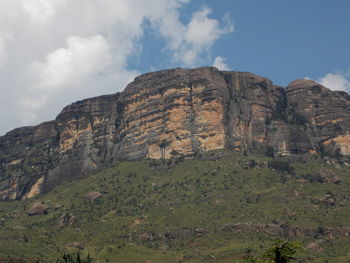 Low angle view of rock formation against sky