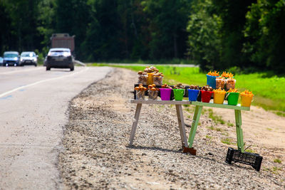 Roadside mushroom sale with selective focus and blurry forest background. daytime sunny weather.