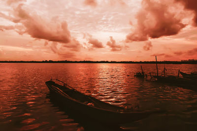 Boat in sea during sunset