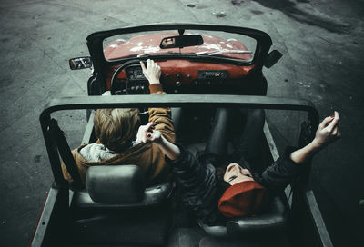 High angle view of men sitting in car