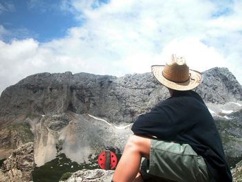 Rear view of person standing on rock