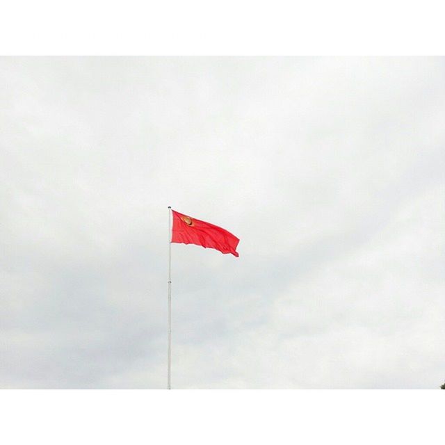 LOW ANGLE VIEW OF FLAGS HANGING ON POLE