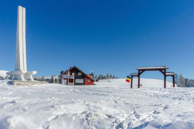 Built structure on beach against clear blue sky