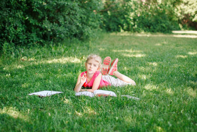 Portrait of girl lying on grass