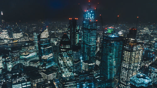 Aerial view of illuminated buildings in city at night