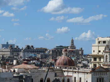 View of cityscape against cloudy sky