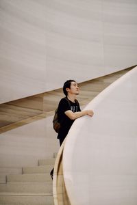 Young man standing on steps