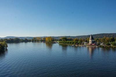 Scenic view of lake against clear blue sky