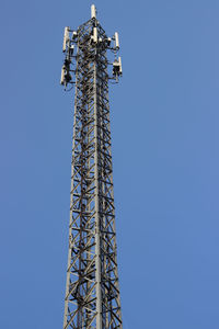Low angle view of communications tower against sky