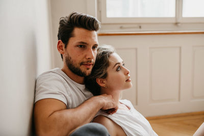 Young couple sitting at home