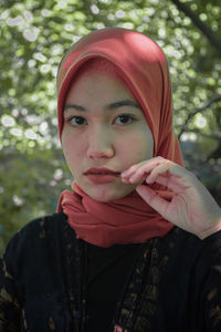 Portrait of beautiful young woman standing outdoors