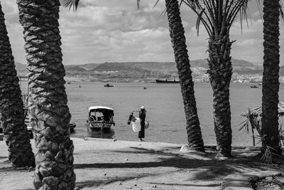 People at beach against sky