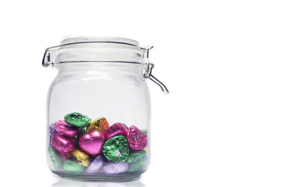 Close-up of multi colored jar against white background