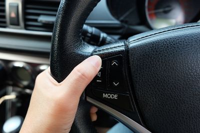 Close-up of human hand in car