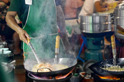 Midsection of man preparing food