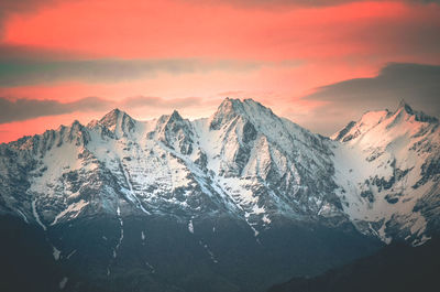 Scenic view of snowcapped mountains against sky during sunset