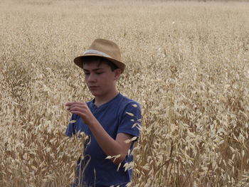 Boy wearing hat while standing on field