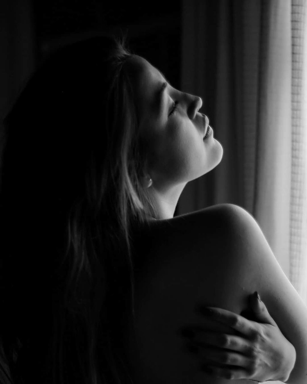 black, black and white, one person, women, monochrome photography, indoors, monochrome, adult, young adult, darkness, female, sadness, long hair, emotion, person, white, contemplation, looking, depression - sadness, portrait, hairstyle, side view, headshot, loneliness, human face, portrait photography, lifestyles, profile view, solitude, domestic room, window, human mouth, dark