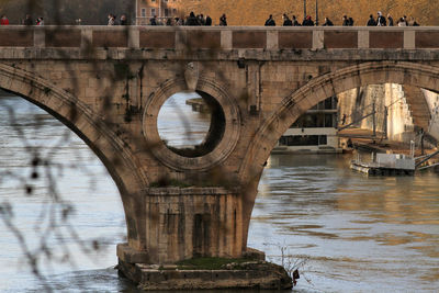 Detail of arch of roman bridge seen from the quay of the tiber river