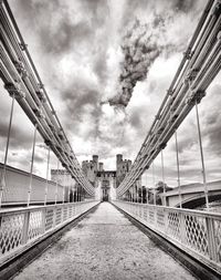 Bridge against cloudy sky