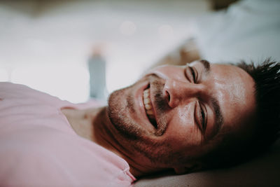 Portrait of man lying on bed