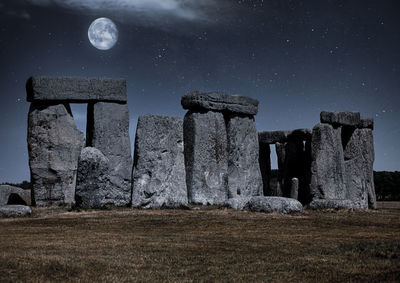 Old ruin on field against sky at night