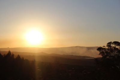 Scenic view of silhouette mountains against sky during sunset