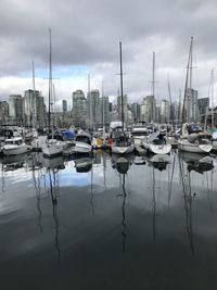 Sailboats moored at harbor