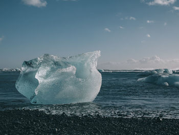 Frozen sea against sky