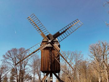 Low angle view of traditional windmill against clear sky