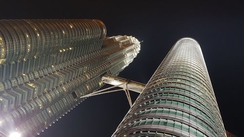 Low angle view of illuminated building against sky at night