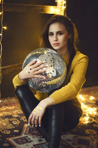 Portrait of young woman sitting outdoors